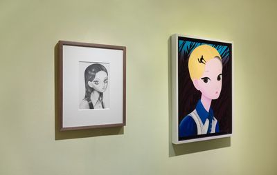 Two artworks displayed side by side on a wall