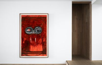 installation view of a red rectangular painting hung on a white wall next to a doorway