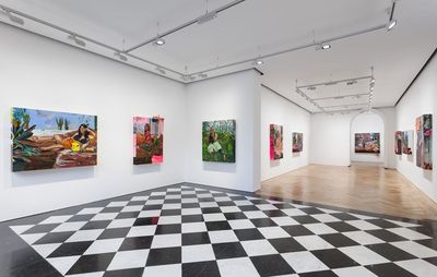 installation view of a black and white tiled floor with paintings hung on white walls