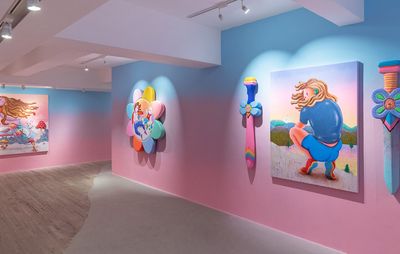 blue and pink gallery walls where three paintings by superfuturekid hang, one of which is flanked by two colourful swords pointing downwards