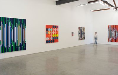 Four of Sarah Morris' artworks across two walls in a white gallery space
