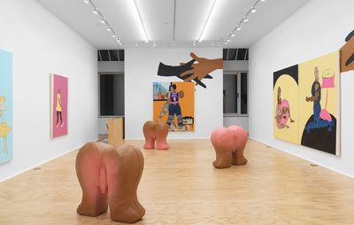 gallery space with a series of paintings, murals and pink-brown fleshy sculptures