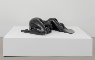 Female sculpture, lying down on a white block