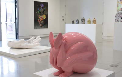 Pink animal sculpture, crouching down on a white block