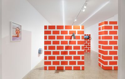 Three artificial brick walls in a gallery space