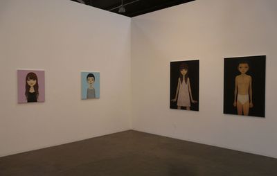 Installation view of four paintings hung across two white walls