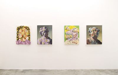 installation view of four similar sized paintings aligned and hung on a wall