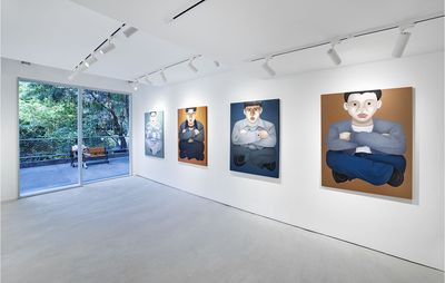 Four paintings of men sitting down in a row on the wall