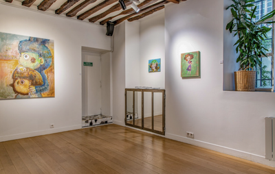 Three paintings on three different walls, three different sizes above a wooden floor