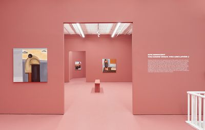 an installation view of a two exhibition rooms with pink walls and three paintings hung