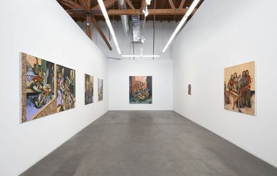 installation view of a long white room with various sized surrealist paintings hung