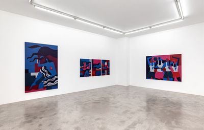 Three brightly coloured paintings hang on white walls jn a gallery in Paris. Each image shows faceless women, captured in blue, red and pink with black accents.