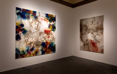 installation view of white walls with two large abstract, square paintings