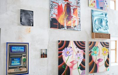 Multiple artworks hanging across a large wall