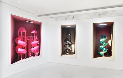 installation view of three images hung of swirling slides