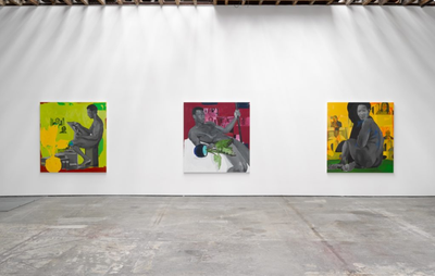 Three brightly coloured paintings on a white wall in a row