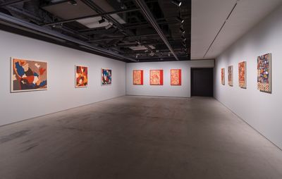installation view of grey room with three to four paintings on each wall