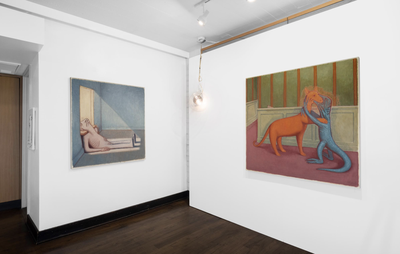 Two of Clayton's paintings hanging across two walls, black wooden floorboards