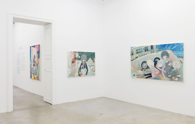 installation view of white walls with two paintings hung on them next to a doorway