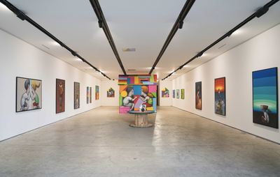 Paintings displayed in a large gallery room