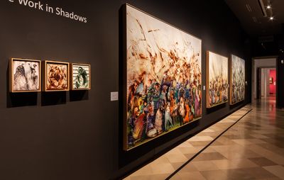 installation view of exhibition title on a black wall, with three small paintings below it and three large paintings to the side of it