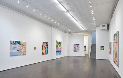 a selection of colourful paintings spread across a gallery room