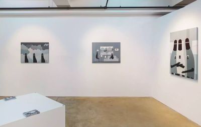 installation view of three greyscale paintings hung on white walls