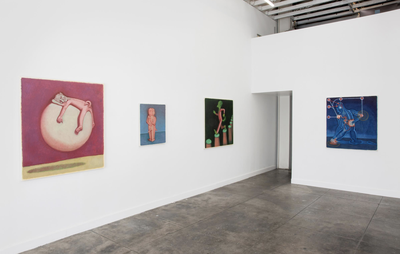 Four small paintings across two white walls in a gallery space