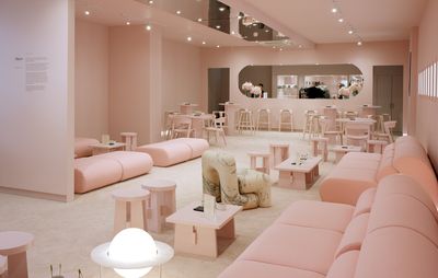 Pink room with pink furniture displaying digital artworks