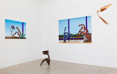 an installation view of two metallic sculptures and two paintings of figures and blue skies 