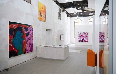 White gallery space showing three paintings