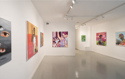 installation view of numerous paintings by different artists hung on white walls