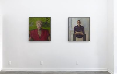 installation view of two portrait paintings hung alongside one another on a white wall