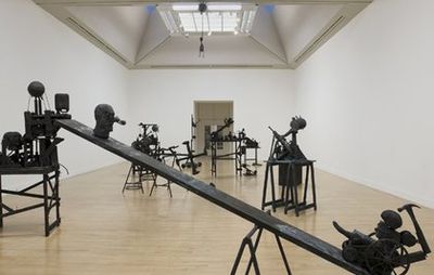 installation view of numerous sculptures and mechanisms in an exhibition space
