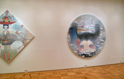 installation view of diamond painting hung next to a tondo painting