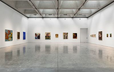 installation view of a variety of paintings hung up in a large gallery space