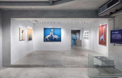 installation view of numerous dinosaur paintings hung on gallery walls