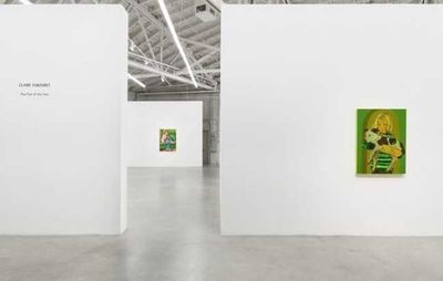 installation view of two white walls with a gap between them, an exhibition title on one and a small painting on another