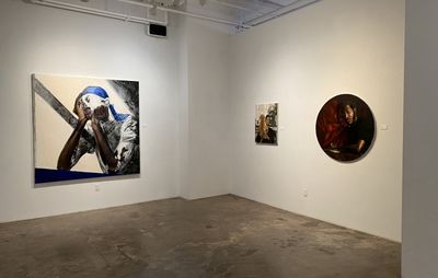 installation view of a white room with three paintings of varying shapes and sizes