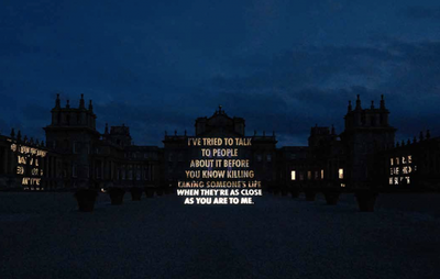 silhouette of Blenheim Palace with illuminated text projected onto the facade