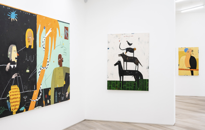 Three paintings hanging in a white gallery space