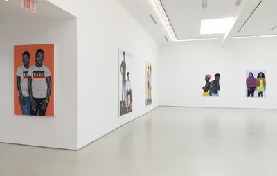 installation view of three white walls, each with a selection of figurative paintings hung up depicting two people