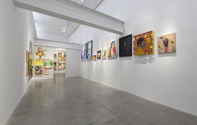 installation view of white gallery space with a row of paintings hung on the wall by different artists