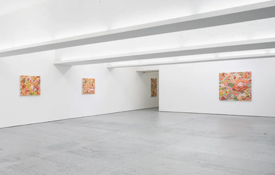five colourful semi-abstract paintings in a large white-walled gallery space