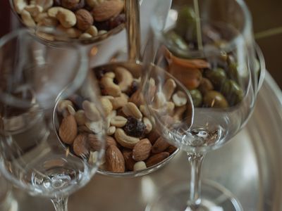 Nuts on a tray with wine glasses