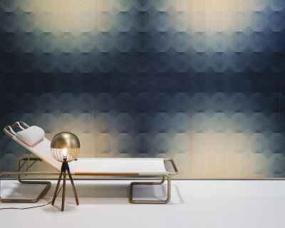A white lounge chair is placed in front of a navy blue and circular tan patterned Veneer Panel wall.