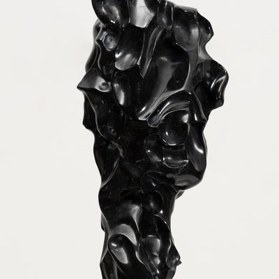 black marble sculpture in an organic shape on a bronze pole by Kevin Francis Gray - close up