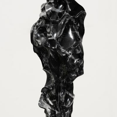 white marble sculpture resembling a face on a bronze pole by Kevin Francis Gray - side view