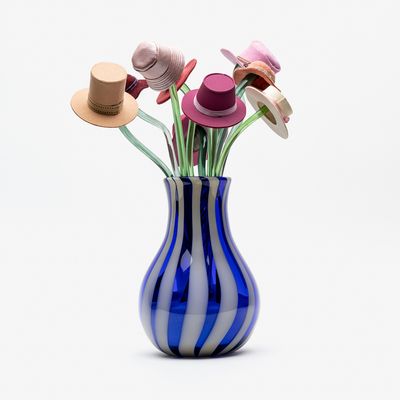 Striped glass vase with mixed material hats