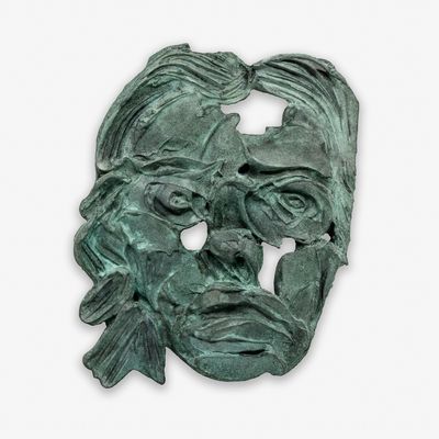 sculptural mask of a woman in green patina